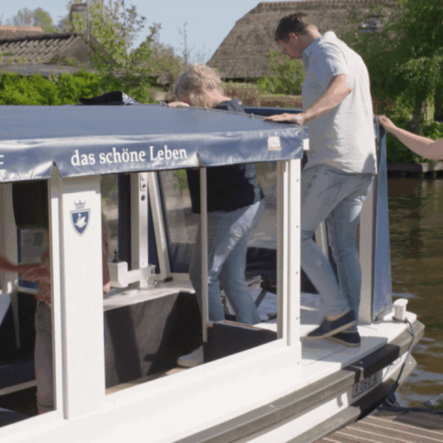 Boarding a canal cruise boat in Giethoorn