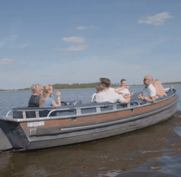 Family enjoying electric boat tour in Giethoorn