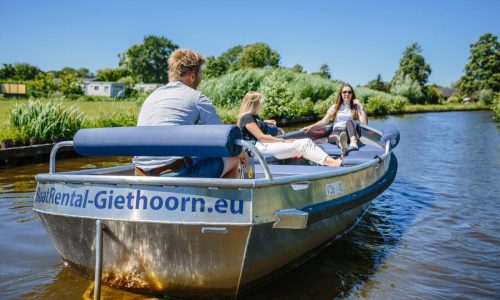 Couple enjoying electric boat ride in Giethoorn