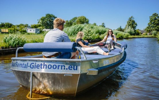 Couple enjoying electric boat ride in Giethoorn