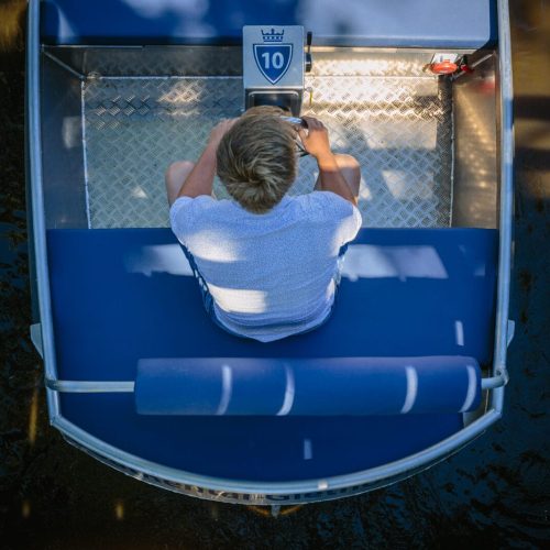 Person driving an electric boat in Giethoorn Netherlands