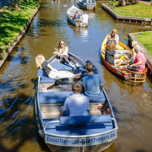 Outboard motor boat on the calm waters of Giethoorn